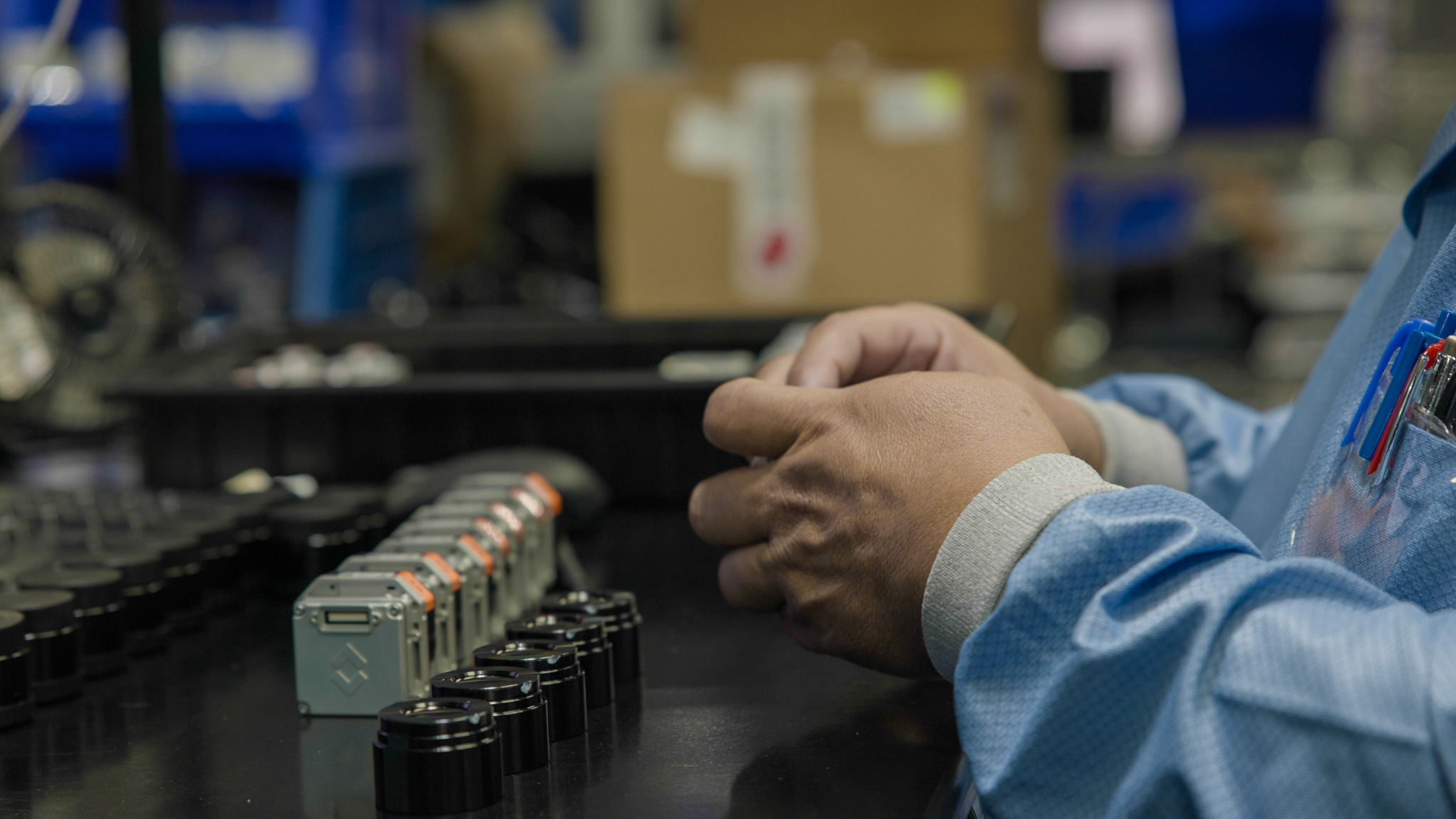 technician assembling camera